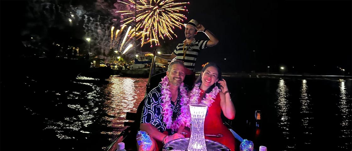 Venetian gondola on the Pacific at sunset with Waikiki fireworks