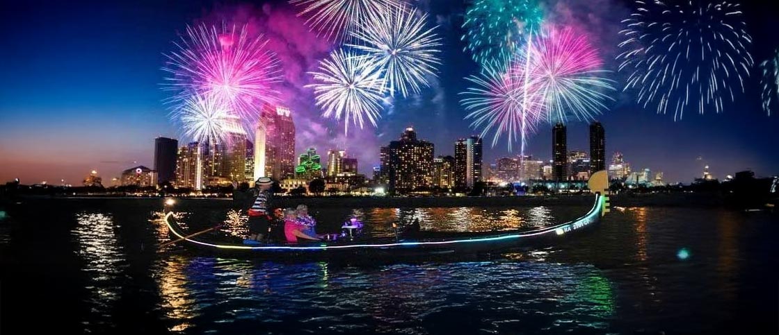 Venetian gondola on the Pacific at sunset with Waikiki fireworks