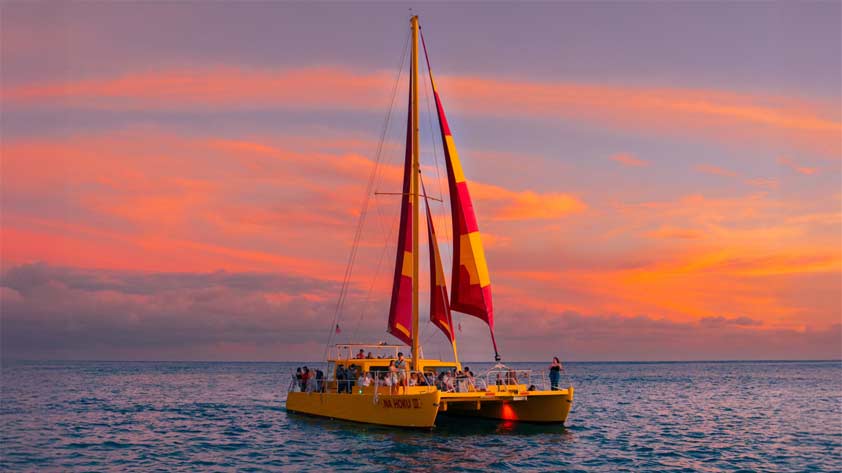 Na Hoku II yellow and red catamaran Waikiki fireworks